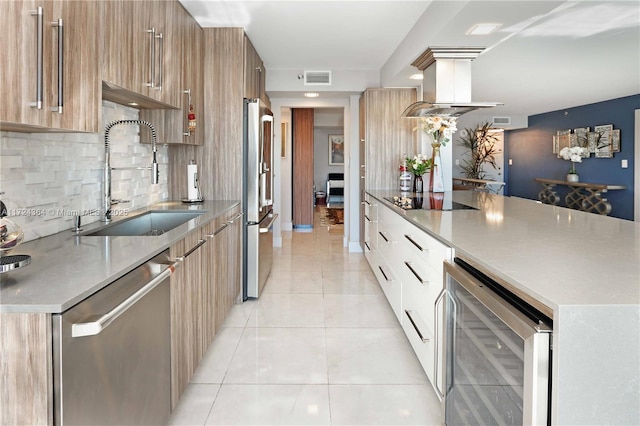 kitchen with appliances with stainless steel finishes, wine cooler, a sink, and modern cabinets