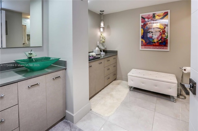 bathroom with vanity, tile patterned floors, and baseboards