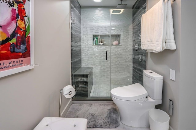 bathroom with toilet and a shower stall