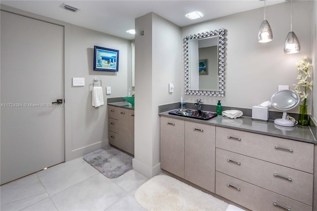 bathroom featuring tile patterned flooring, visible vents, and vanity