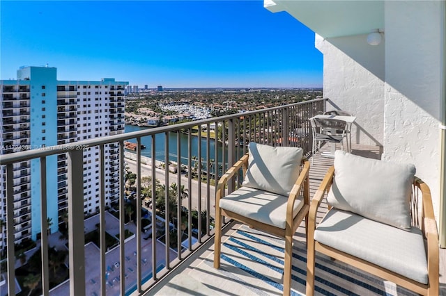 balcony featuring a view of city and a water view