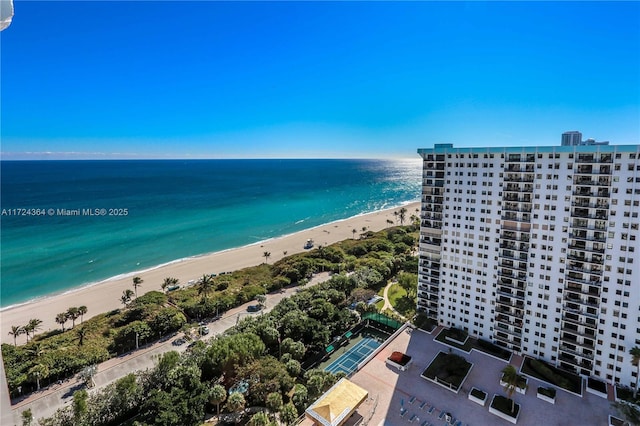 bird's eye view featuring a water view and a beach view