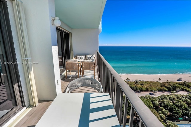 balcony with a water view and a beach view