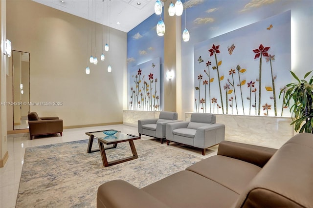 living area with baseboards and a towering ceiling