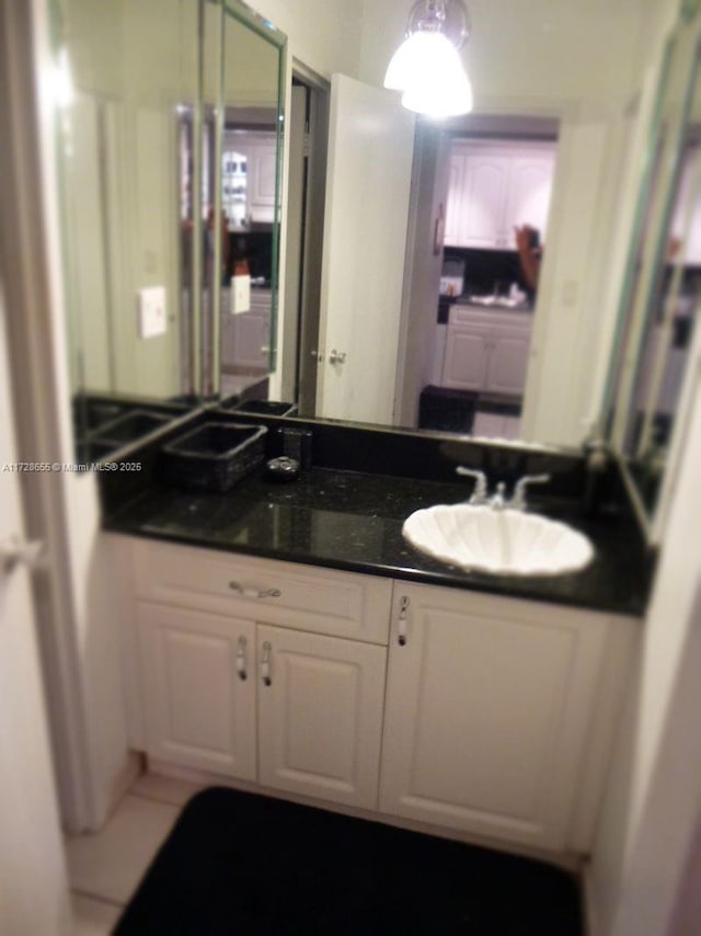 bathroom with tile patterned floors and vanity