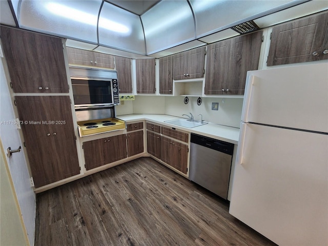 kitchen with dark wood-type flooring, sink, and stainless steel appliances