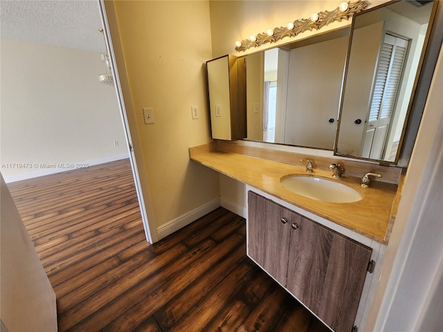 bathroom featuring vanity, a textured ceiling, and hardwood / wood-style flooring