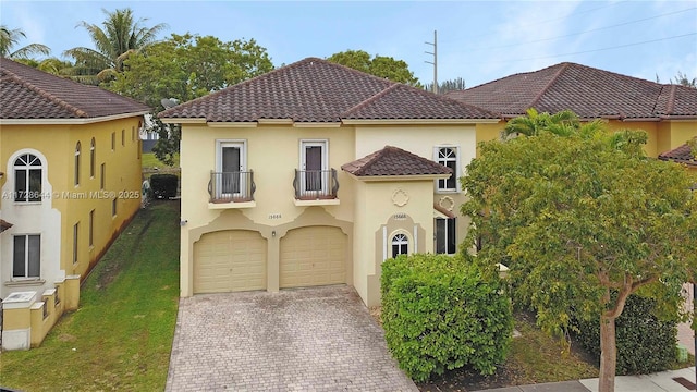 mediterranean / spanish-style house featuring a balcony and a front lawn