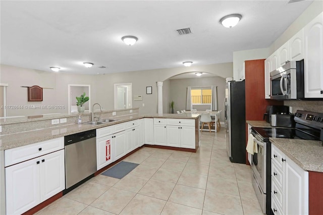 kitchen with white cabinetry, appliances with stainless steel finishes, sink, and kitchen peninsula