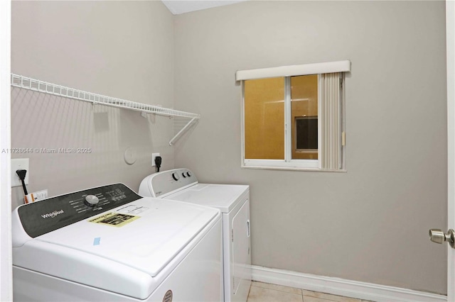 laundry area with light tile patterned flooring and separate washer and dryer