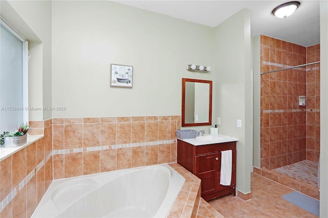 bathroom featuring vanity, tile patterned flooring, and shower with separate bathtub