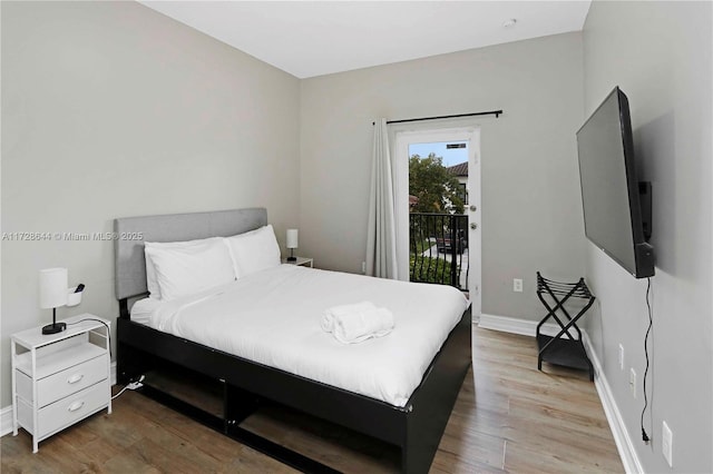 bedroom featuring hardwood / wood-style flooring and access to outside