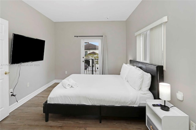 bedroom featuring hardwood / wood-style flooring and access to outside