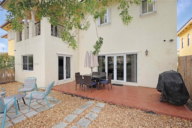 rear view of house featuring a patio area and french doors