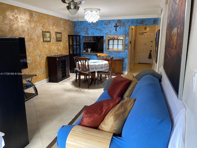 tiled living room featuring a textured ceiling, an inviting chandelier, and ornamental molding