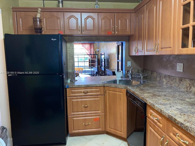 kitchen with black appliances, light tile patterned floors, and sink