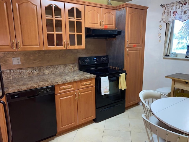 kitchen with light tile patterned flooring and black appliances