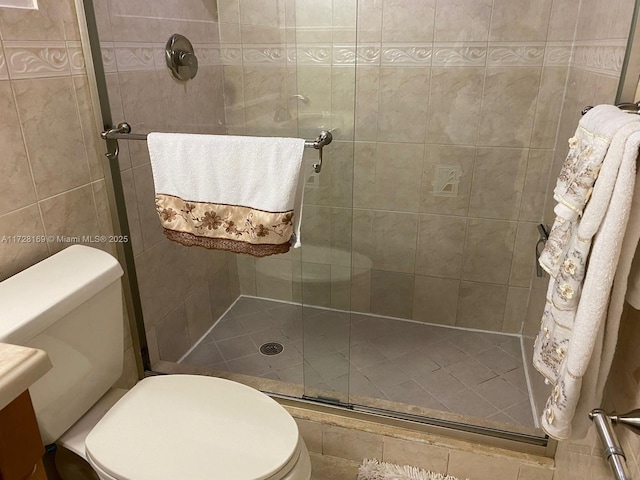 bathroom featuring walk in shower, vanity, and toilet