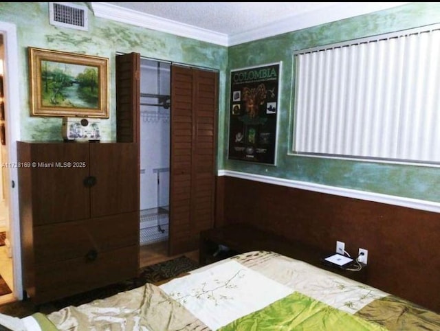 unfurnished bedroom with ornamental molding, a closet, and a textured ceiling