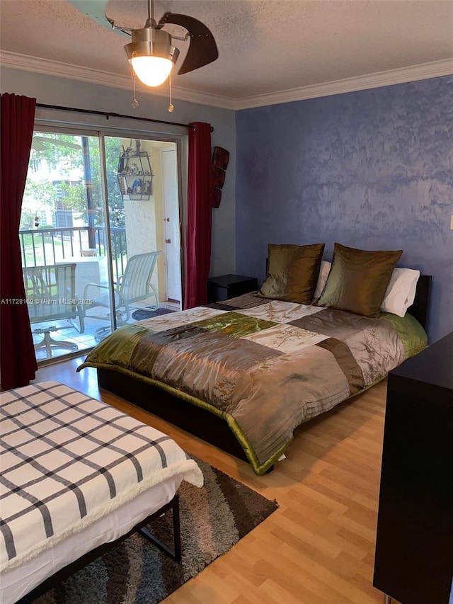 bedroom with a textured ceiling, ceiling fan, access to exterior, ornamental molding, and hardwood / wood-style flooring