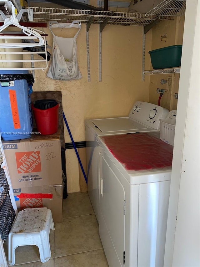 laundry room with washer and dryer and light tile patterned flooring