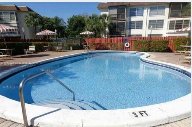 view of swimming pool featuring a patio area