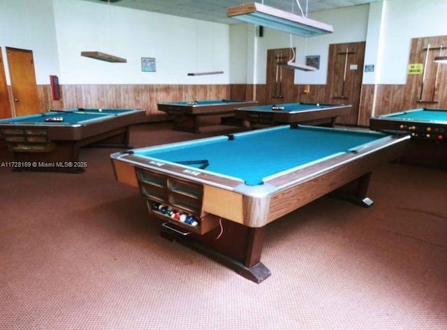 rec room featuring billiards, wooden walls, and dark colored carpet