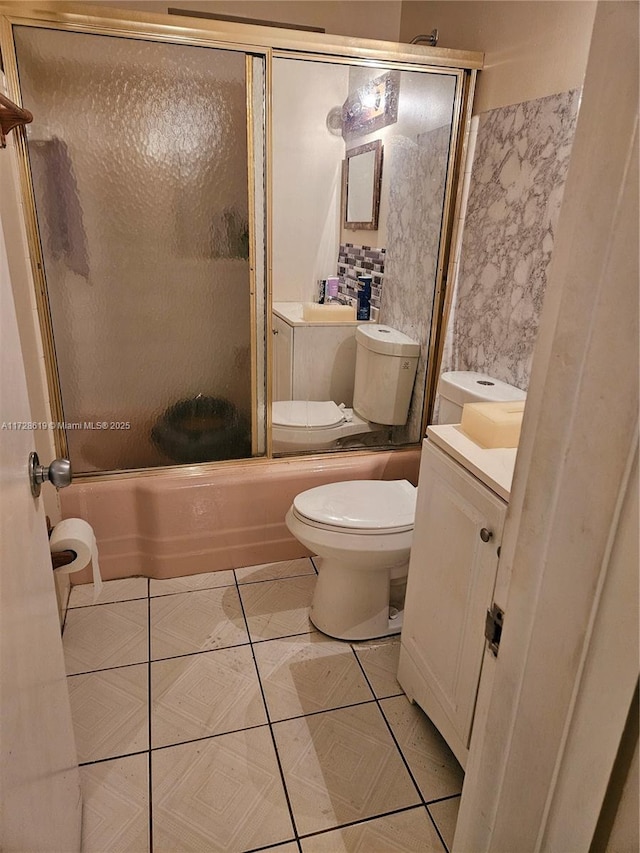 full bathroom with vanity, combined bath / shower with glass door, and toilet