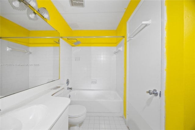 full bathroom featuring tiled shower / bath combo, vanity, toilet, and tile patterned flooring