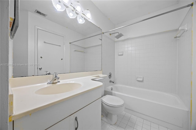 full bathroom featuring tile patterned flooring, vanity, tiled shower / bath combo, and toilet