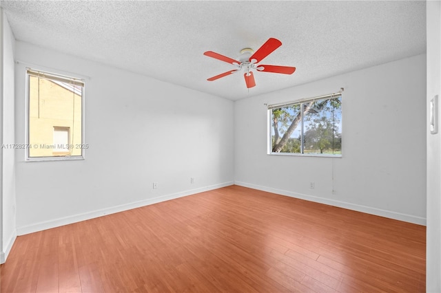 unfurnished room with ceiling fan, a textured ceiling, and hardwood / wood-style flooring