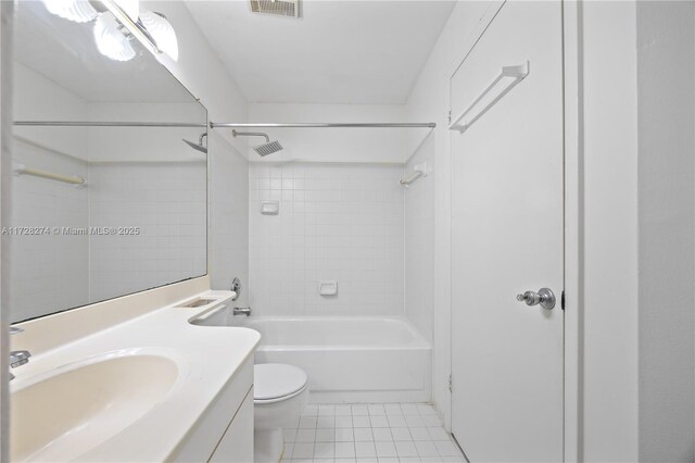 full bathroom featuring tile patterned flooring, vanity, tiled shower / bath combo, and toilet