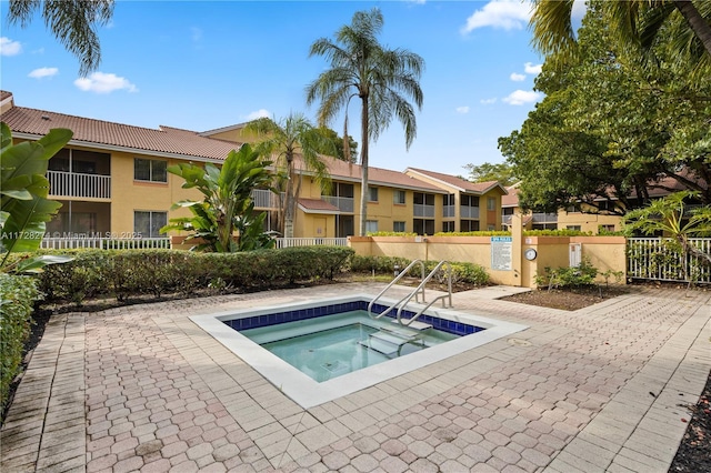 view of pool with a community hot tub