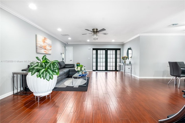 living room featuring ceiling fan, dark hardwood / wood-style flooring, ornamental molding, and french doors