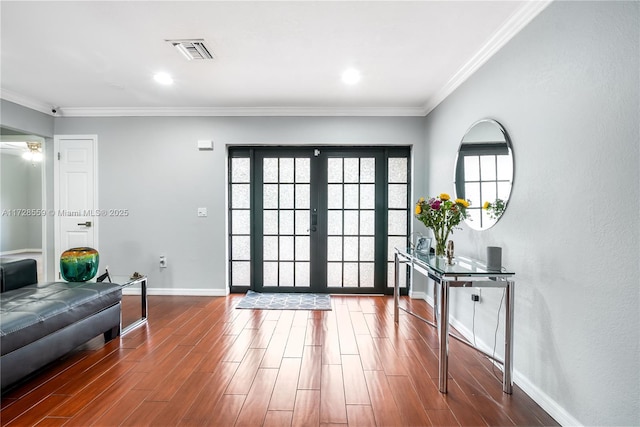 interior space with ornamental molding and french doors