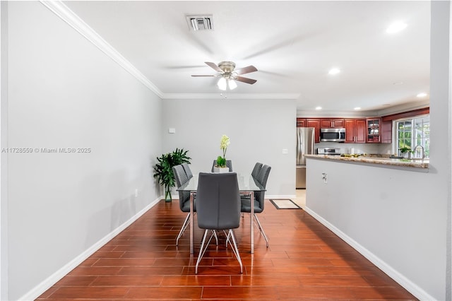 dining space with ceiling fan, ornamental molding, and dark hardwood / wood-style flooring