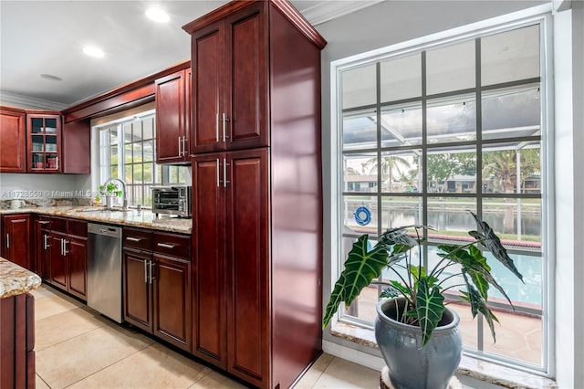 kitchen featuring light stone countertops, light tile patterned floors, stainless steel dishwasher, and sink