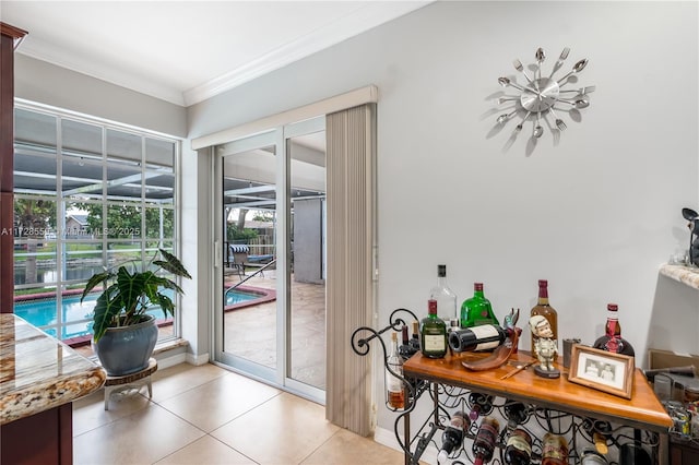 doorway to outside featuring light tile patterned floors and ornamental molding