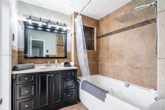 bathroom with tile patterned flooring, vanity, tile walls, and shower / bathtub combination with curtain