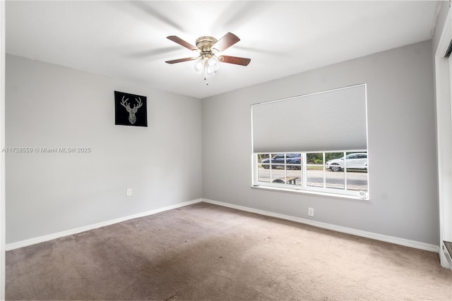 carpeted empty room featuring ceiling fan