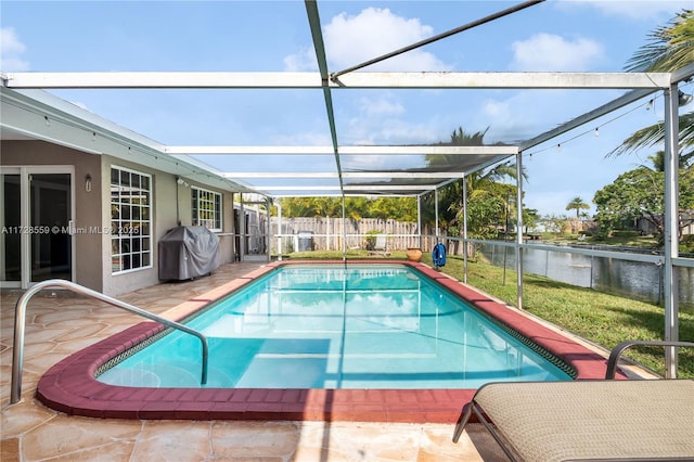 view of pool featuring a water view, a patio, grilling area, and a lanai