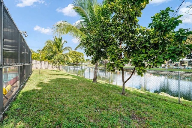 view of yard featuring a lanai and a water view