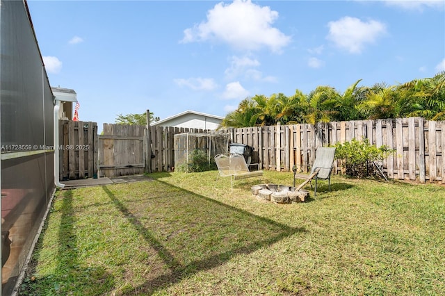 view of yard with an outdoor fire pit