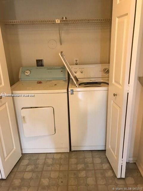 clothes washing area featuring washer and clothes dryer