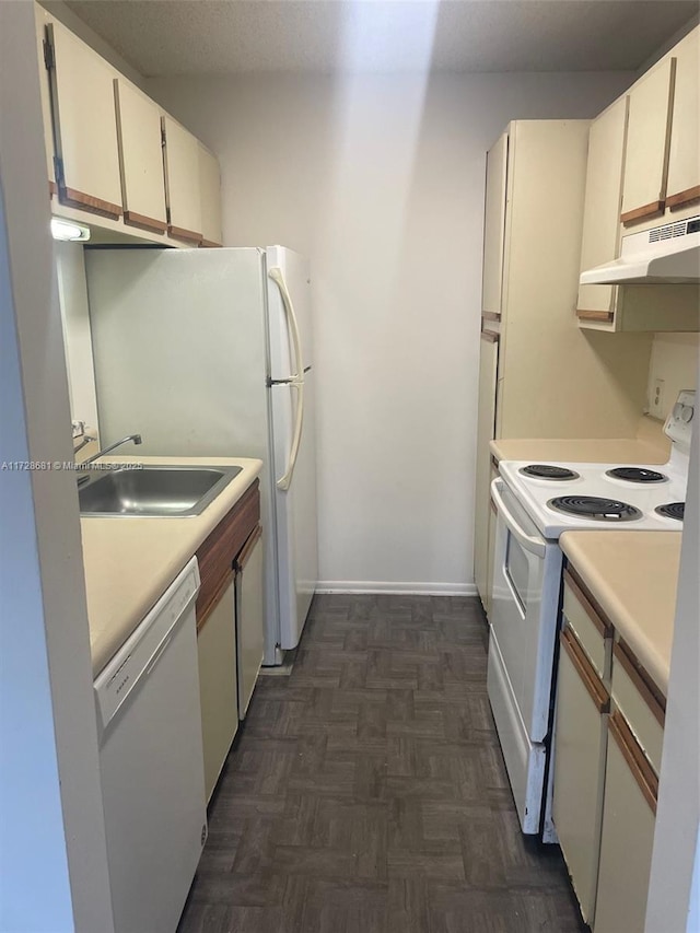 kitchen with white cabinetry, sink, white appliances, and dark parquet floors