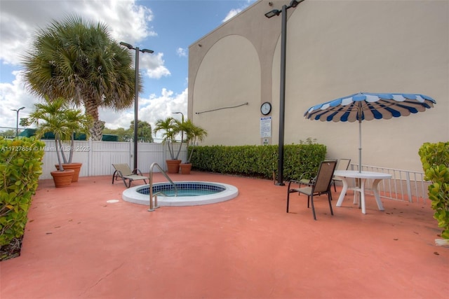 view of swimming pool featuring a hot tub and a patio