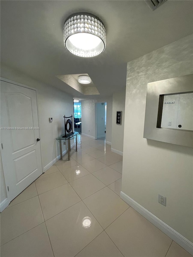 hall featuring light tile patterned flooring