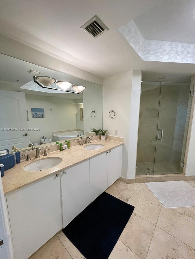 bathroom featuring a shower with shower door and vanity