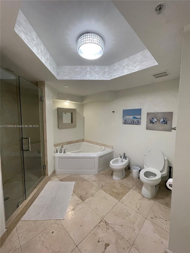 bathroom featuring a bidet, toilet, and separate shower and tub