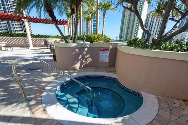 view of pool with a community hot tub and a patio area